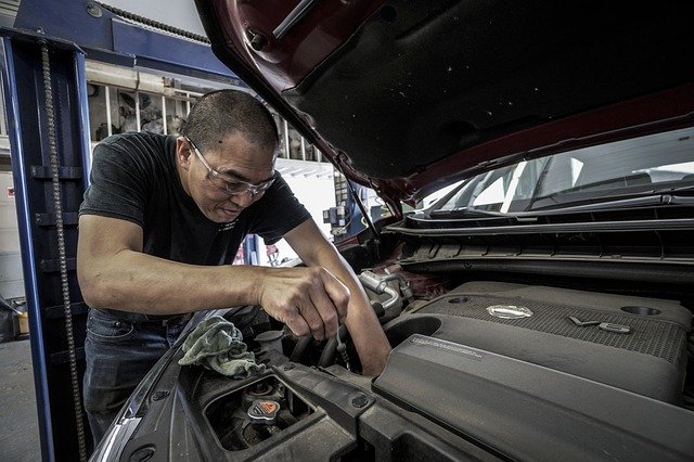man working on car auto repair